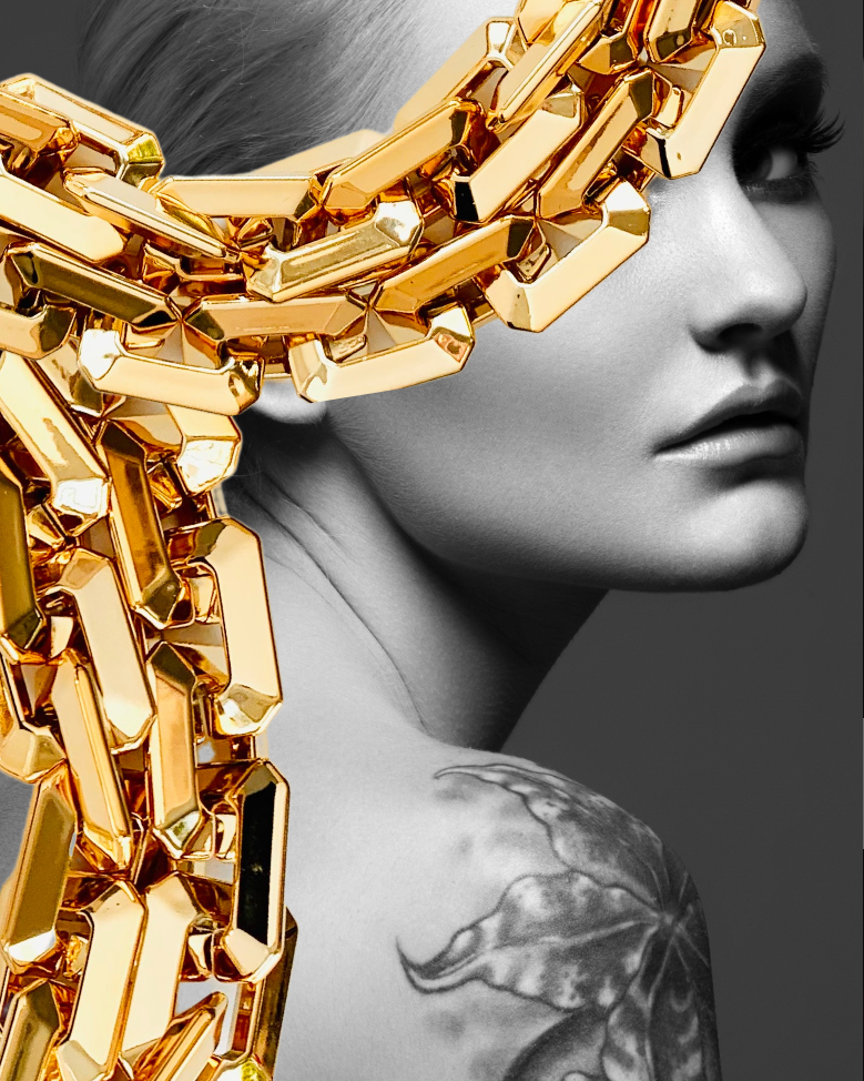 Consultancy Services Page with a visual of female model with chunky gold chains draped over her face