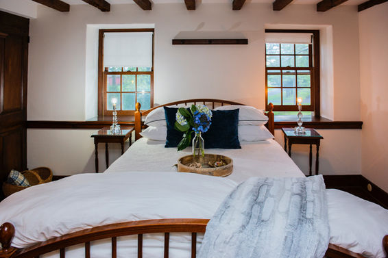 Bedroom with wooden furniture and white bedding
