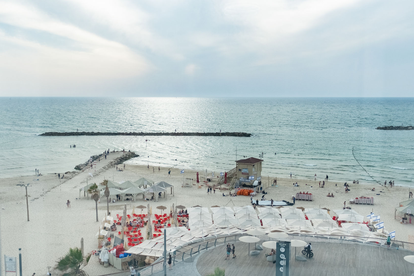 Aerial view of Tel Aviv beach with people and structures; telavivhome