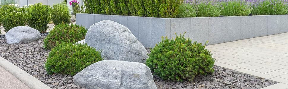 Black marble chips edging a garden bed.