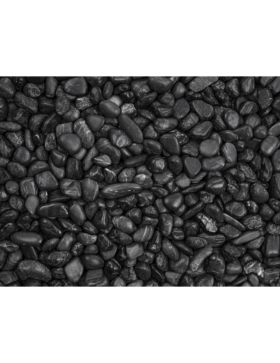 Pile of smooth black mate pebbles.
