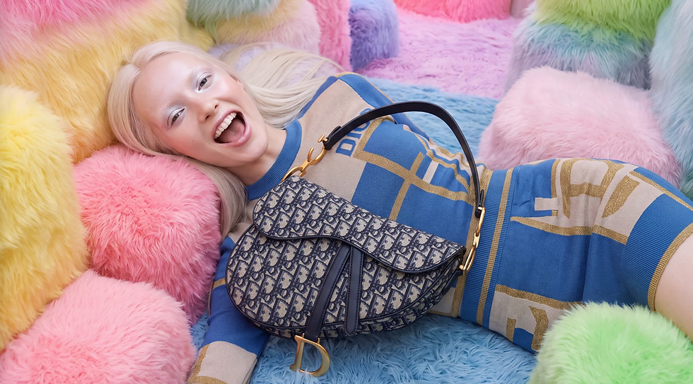 AI model with blonde hair lying on colorful pastel fur cushions with a Dior Saddle Bag - Vertigini Studio
