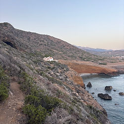 Rocky coastal landscape with white house
