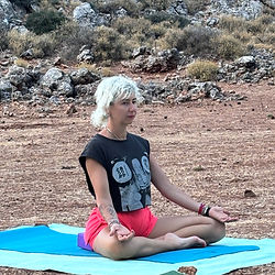 Woman in Lotus pose practicing Forest Yoga outdoors