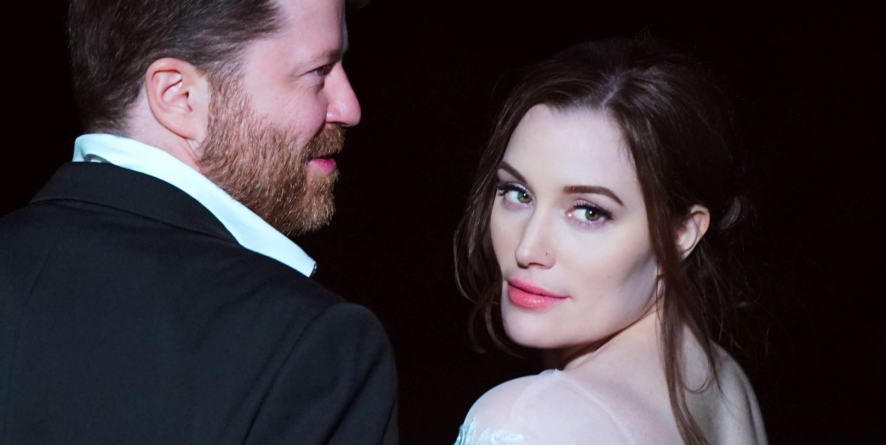 A bride and groom at night with a hard camera flash