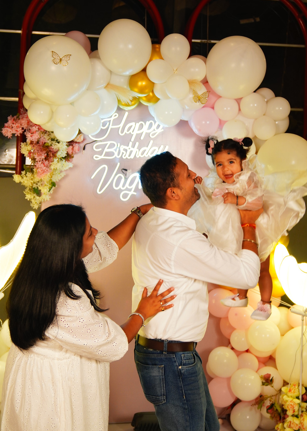 Birthday party celebration with elegant balloon decor and happy family moments.