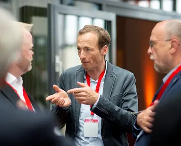 Teilnehmer einer Konferenz im Gespräch