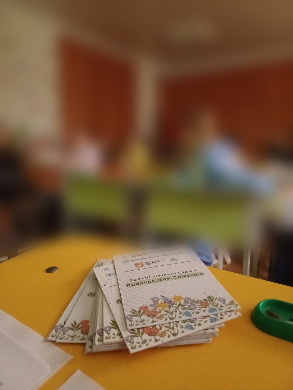 Environmental colouring booklets on a school desk during a garden training session