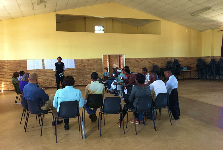 Community meeting inside a hall during the Zwelihle emergency assistance work