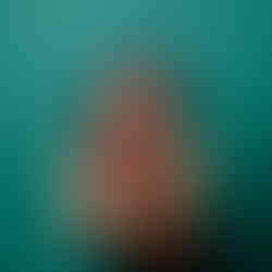 branding photo woman on blue background blowing glitter towards the camera from her hands