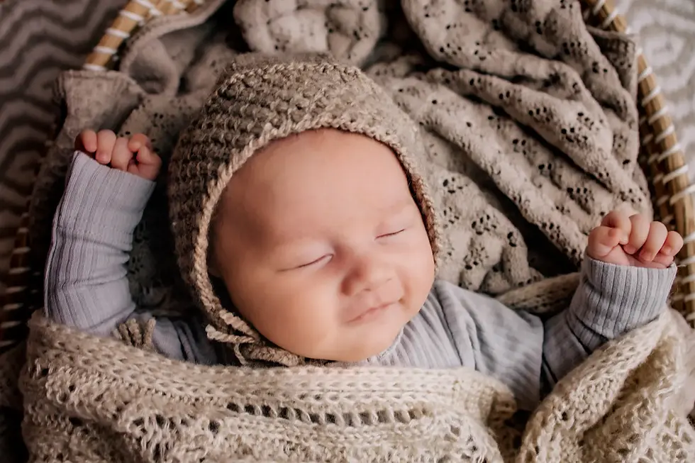 Newborn baby sleeping in knit bonnet