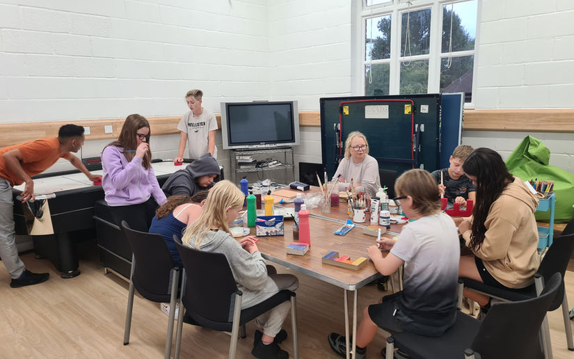 volunteers and young people doing arts and crafts