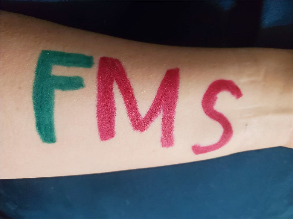 Author's forearm. FMS written in marker.