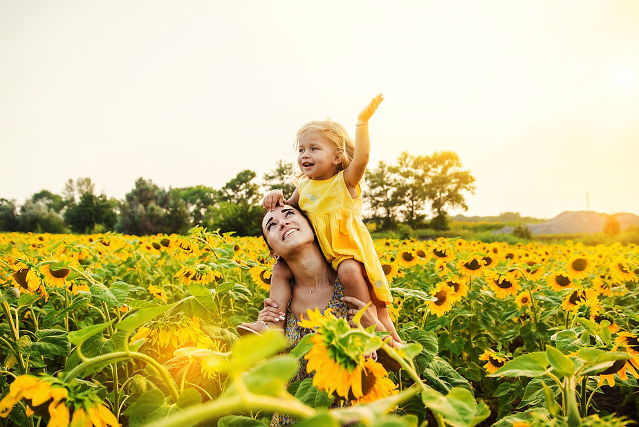 Mom and daughter in the field of sunflowers.jpg