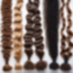 6 different small bundles of hair each depicting a different texture of hair, ranging from soft wave to coily hair