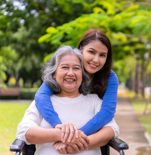 Young woman smiling and hugging older woman from behind