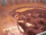 Liquefied nickel ore poses a significant hazard in a bulk carrier's cargo hold, illustrating the dangers of cargo liquefaction at sea.