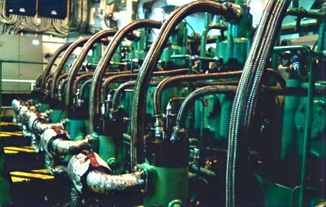 Main propulsion engine of a large ship, showcasing the intricate network of pipes and components essential for powering maritime voyages.