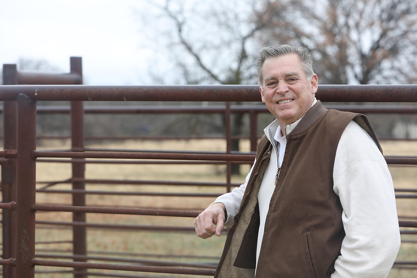 David leaning on fence.jpeg
