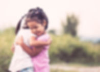 Two-young-girls-hugging-friends_edited.j