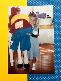 Young Chicago Artist Brie Hines holding a large Madeline doll