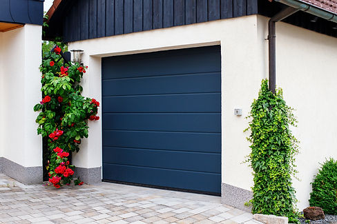 automatic garage doors near manicured blooming roses.jpg
