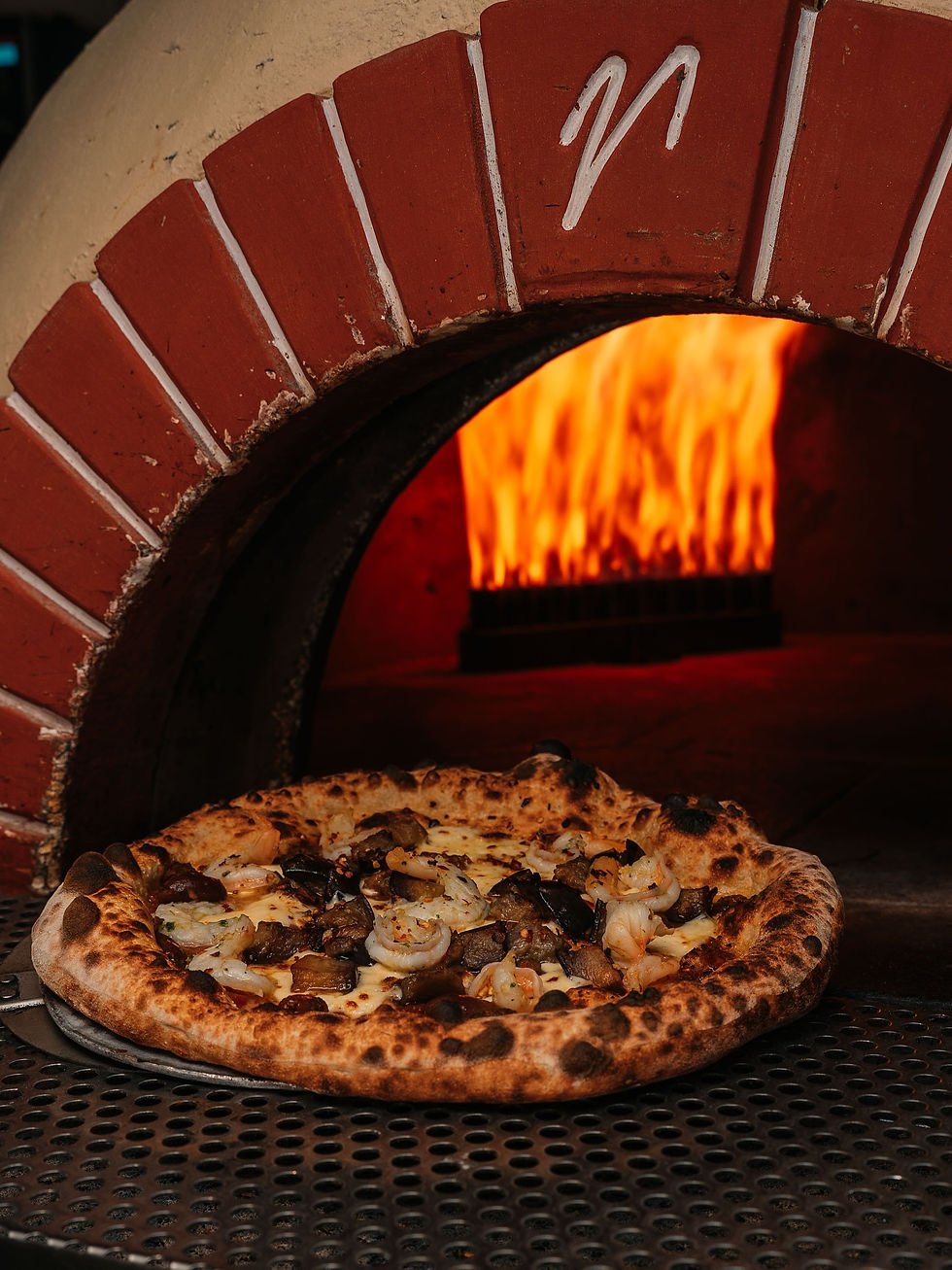 Close-up view of a woodfired Margherita pizza with fresh basil