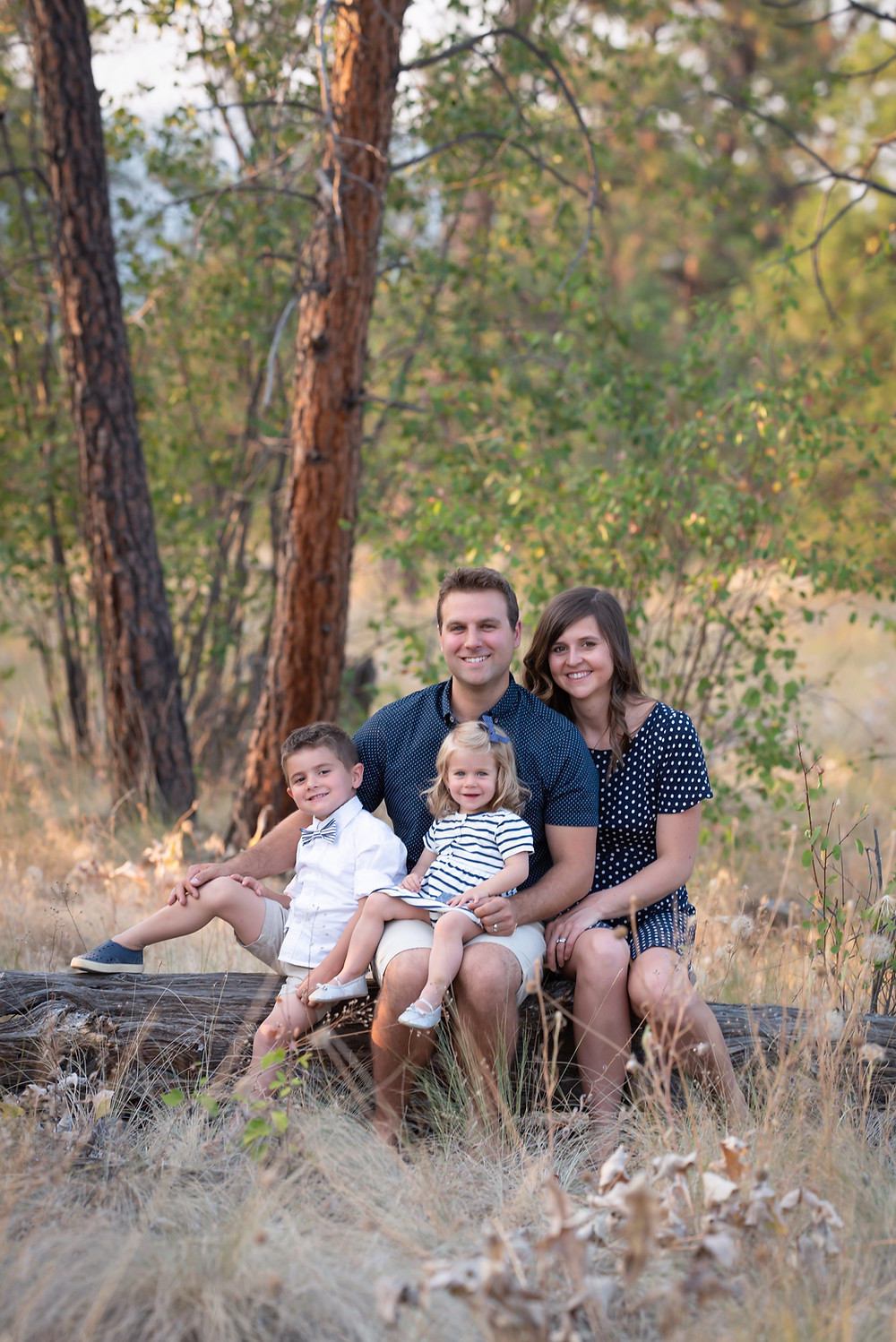 Family in navy on fallen log at Dilworth Mountain Park