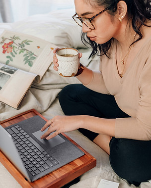 Wellness practitioner working on a laptop during a 1:1 wellness business coaching strategy session.
