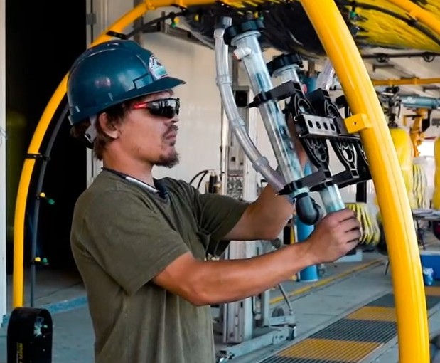 Technician conducting preventative maintenance on tunnel components ensures the system's smooth operation.