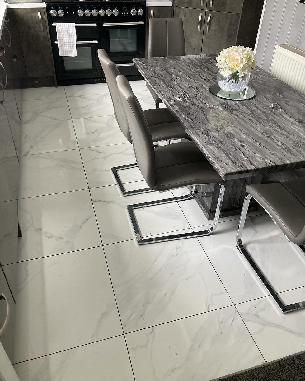 Large format marble-effect floor tiling professionally installed in a contemporary dining area in West Midlands