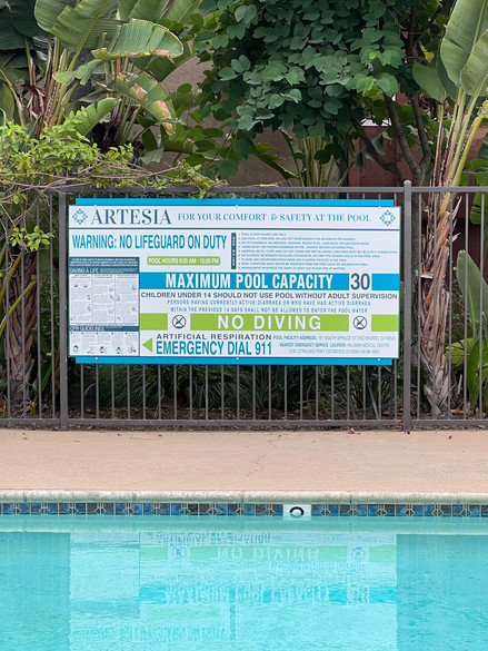 blue, lime green, and white pool safety signage.