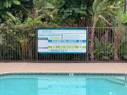 blue white and lime green pool safety and cpr signage for a local community.