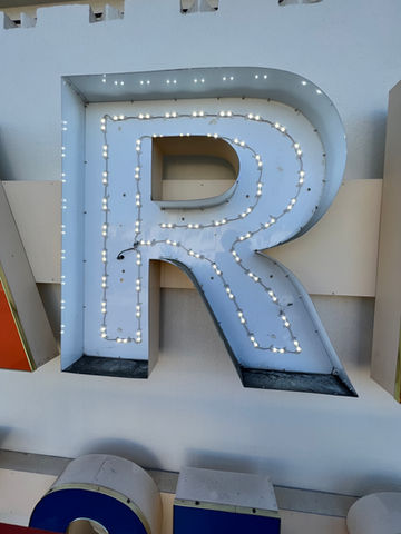 c.p. richards team repairing a channel letter lighting.