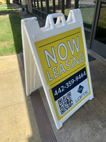 Custom made a-frame made in el cajon, sign is a white frame made from plastic with a yellow background and blue and white font.