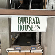 White and green sign for restaurant for burrata house