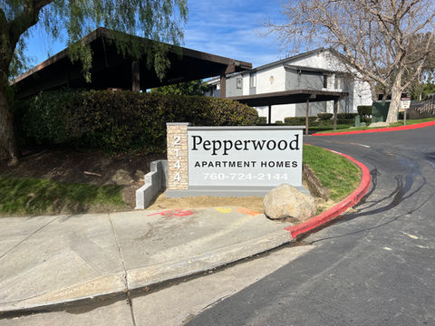 Grey and black sign made for an apartment complex