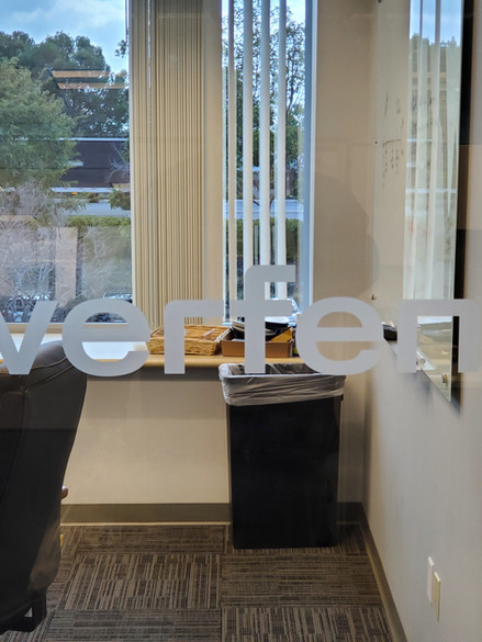 frosted window sticker of the company logo on glass door