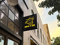 exterior blade sign on side of a building
