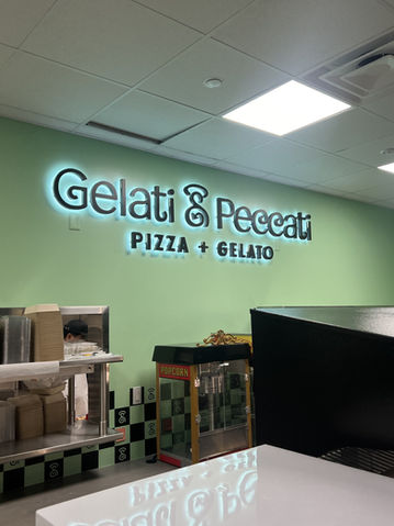 Halo lit restaurant sign that says pizza and gelato