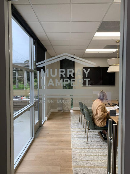 logo made from frosted vinyl for glass door reads murray lampert