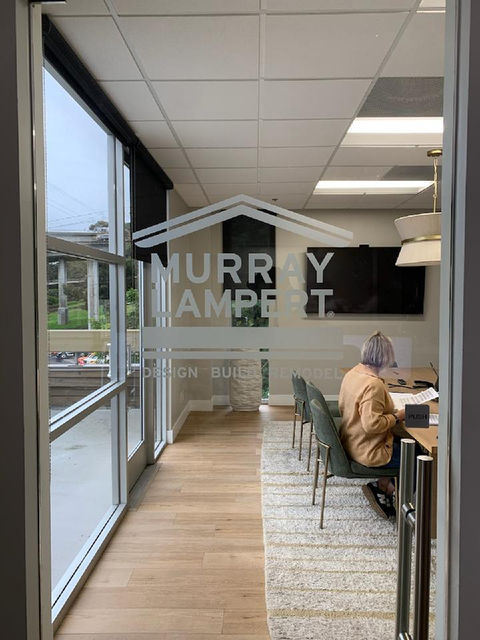 logo made from frosted vinyl for glass door reads murray lampert