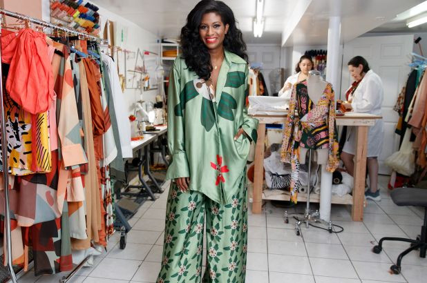Felisha Noel wears her eye-catching, silk designs in light green and orange patterns