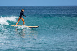 beautiful-surfer-girl-rides-surfboard