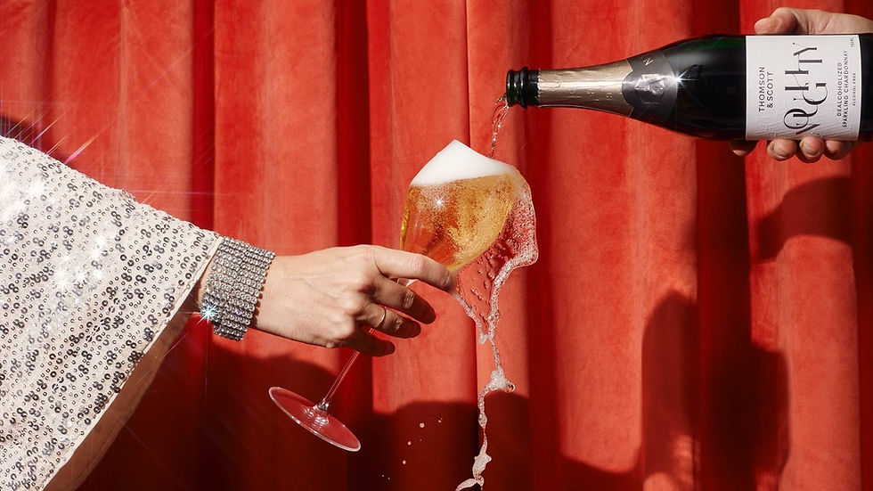 An overflowing glass of Noughty sparkling Chardonnay by Thomson & Scott and NOLO Thailand