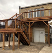 Wooden walkout deck with wood and metal railings in Dutton ON