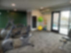 Connolly Lofts fitness center with exercise bikes and yoga equipment
