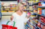 femme qui lit des valeurs nutritionnelles dans un commerce