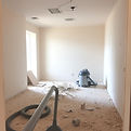 A dusty room or construction site with debris being vacuumed..jpg