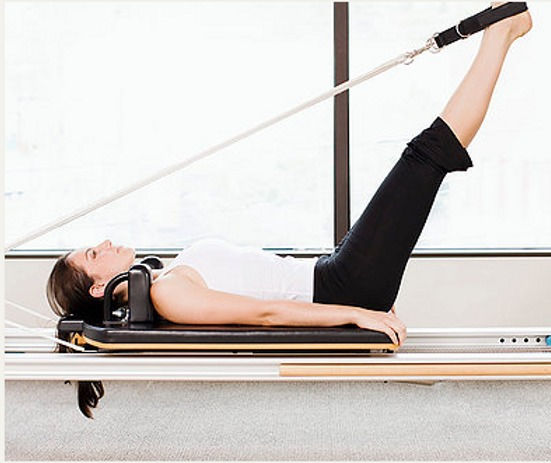 Kim Stokes guiding a client through a mindful Pilates session